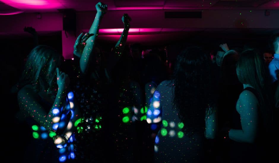 A themed party with disco lights and people dancing