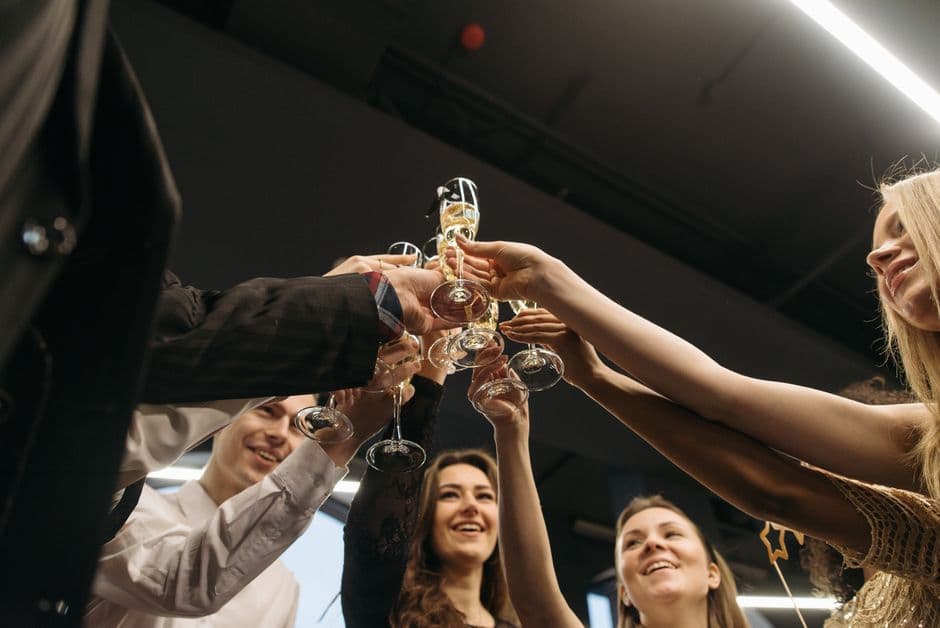 Guests raising a champagne toast at an engagement party