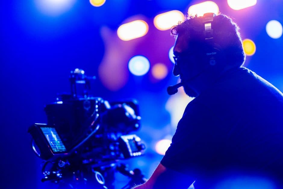 An event crew member with a headset coordinating from side of stage