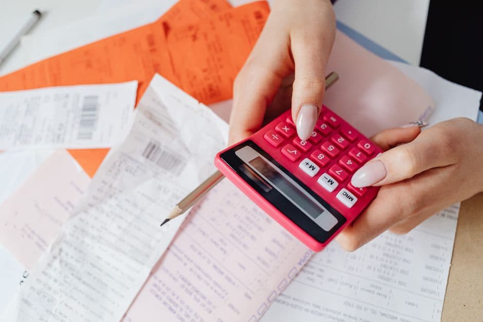 Receipts and a calculator, standing in for event cash flow
