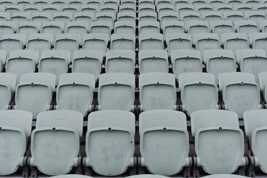 Tiered seating filling up at a live event