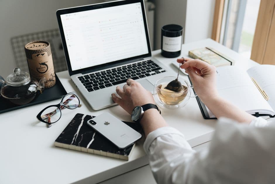An organiser writing an event email on a laptop