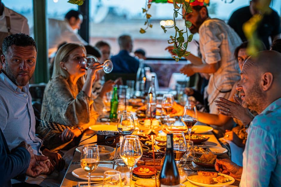 A group sharing a long dinner table at a Christmas function