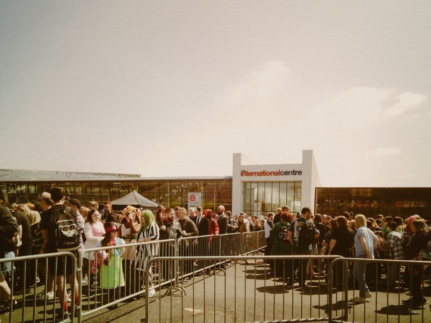 A crowd waiting to get into a busy event