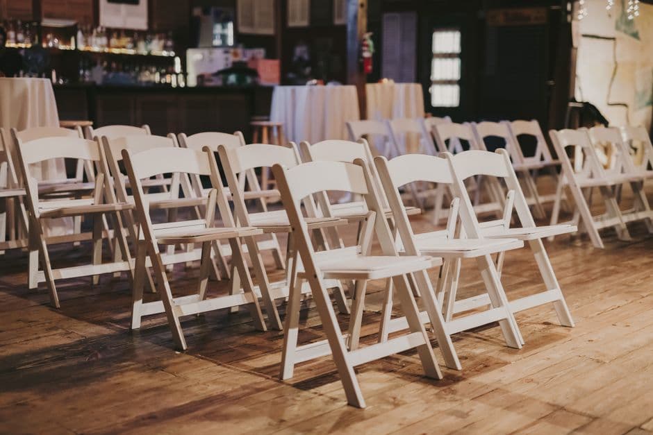 Rows of empty chairs set up in a venue before an event